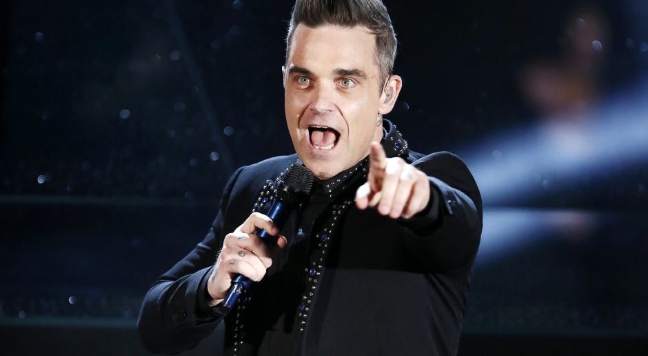 Robbie Williams maakt kans op de grootste Britse onderscheiding. Maar weinigen krijgen die.